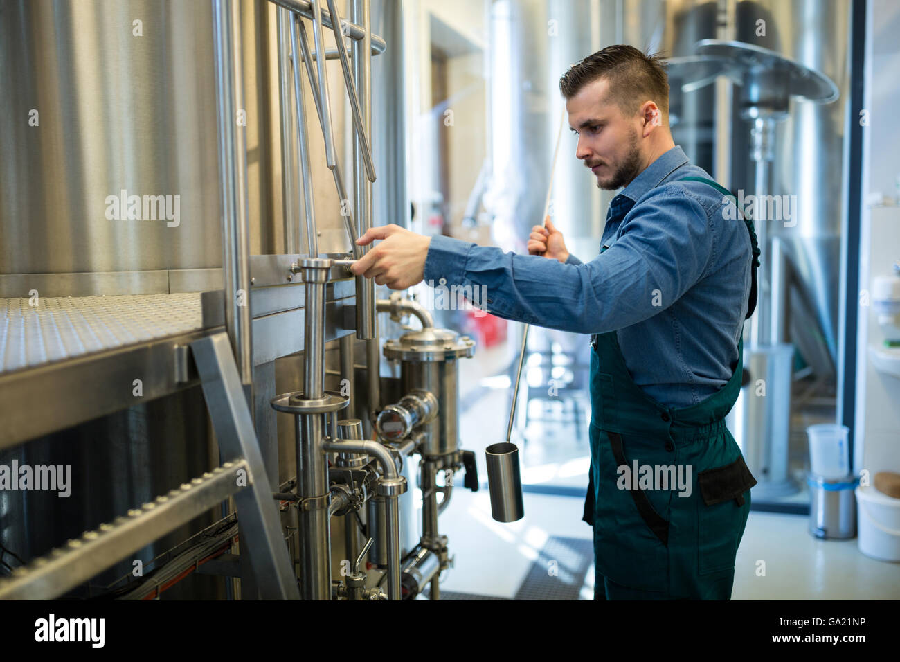 Brewer working at brewery Stock Photo