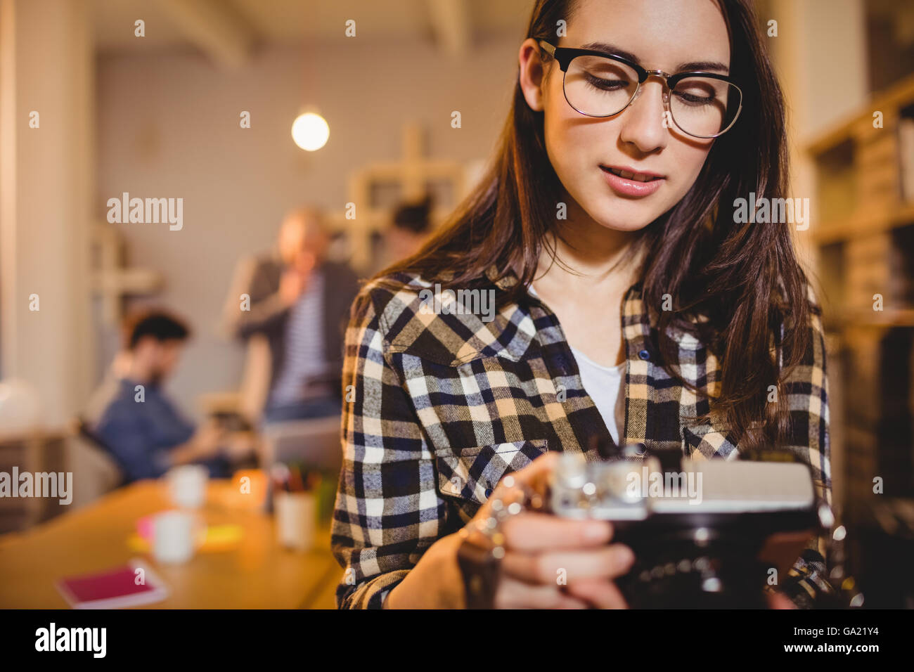 Graphic designer checking pictures in camera Stock Photo - Alamy