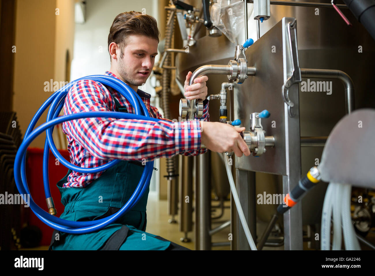 Maintenance workers examining brewery machine Stock Photo Alamy