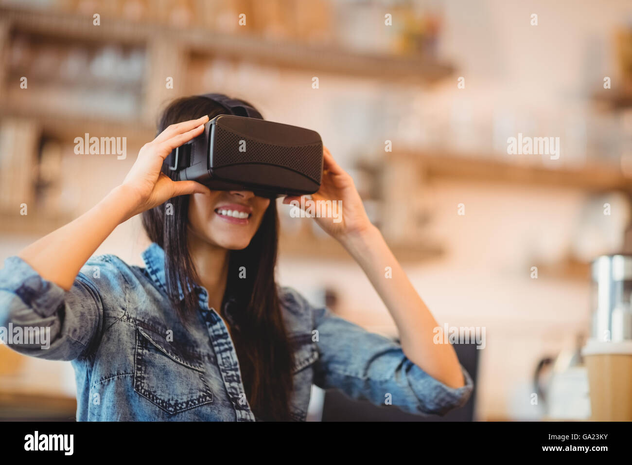 Young woman using the virtual reality headset Stock Photo - Alamy