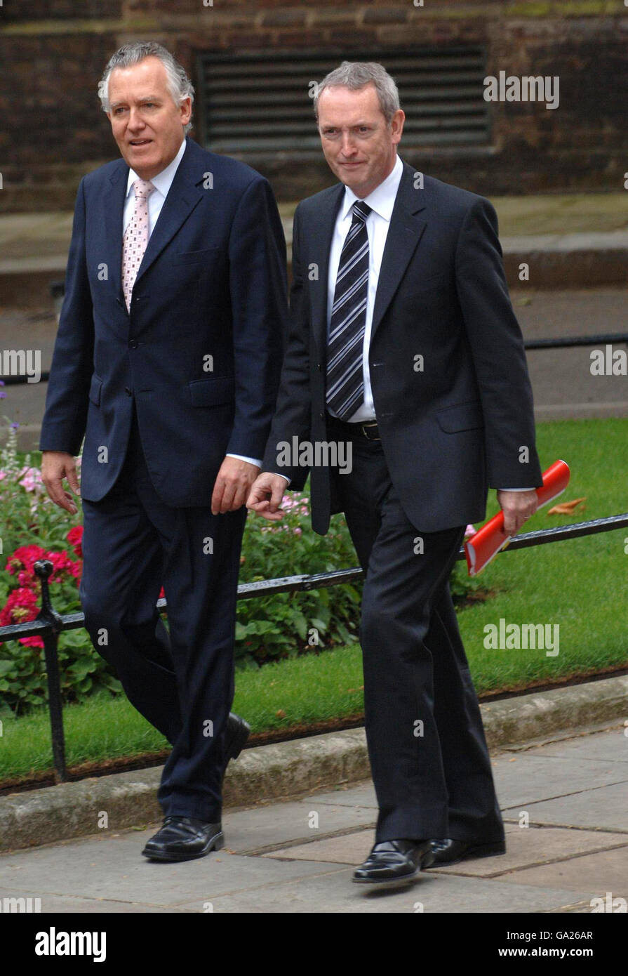 Work and Pensions Secretary Peter Hain and Secretary of State for Business, Enterprise and Regulatory Reform John Hutton in Downing Street, London, arriving for their first cabinet meeting with Prime Minister Gordon Brown. Stock Photo
