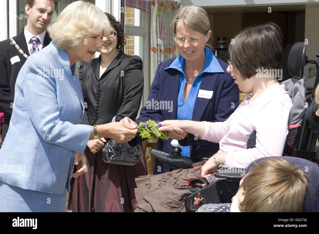 The Duchess of Cornwall is presented with a small bouquet by one of the guests during a visit to Helen and Douglas House, a hospice and respite care centre for children and young adults, in Oxford. Stock Photo