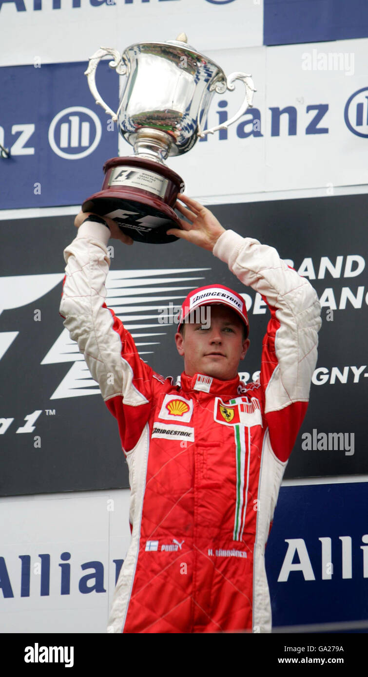 Finland's Kimi Raikkonen celebrates on the podium after winning the French Grand Prix at Magny Cours, Nevers, France. Stock Photo