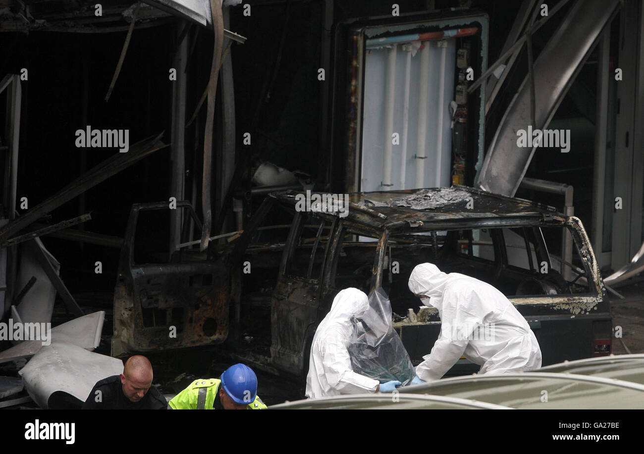 Terminal Forensics Forensic officers carries a gas cannisre wrapped in plastic from the ...