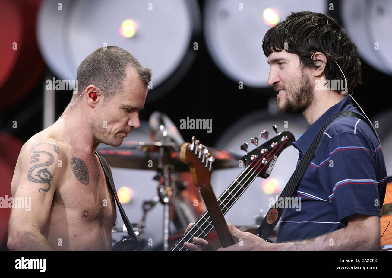 . . Flea and John Frusciante (right) on stage during The Red Hot Chili Peppers performance at the the charity concert at Wembley Stadium, London. Stock Photo