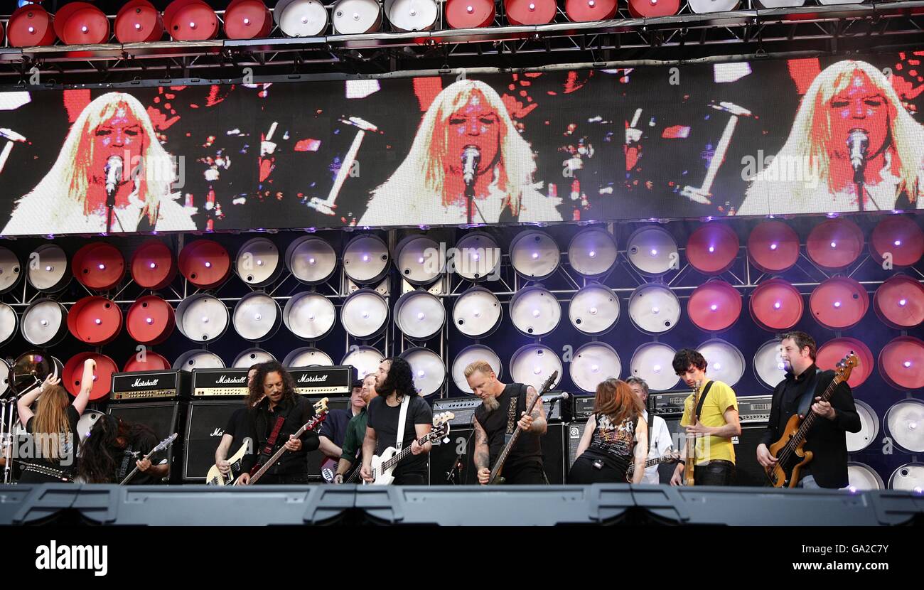 Guitarists perform with the fictional band Spinal Tap perform during the charity concert at Wembley Stadium, London. Stock Photo