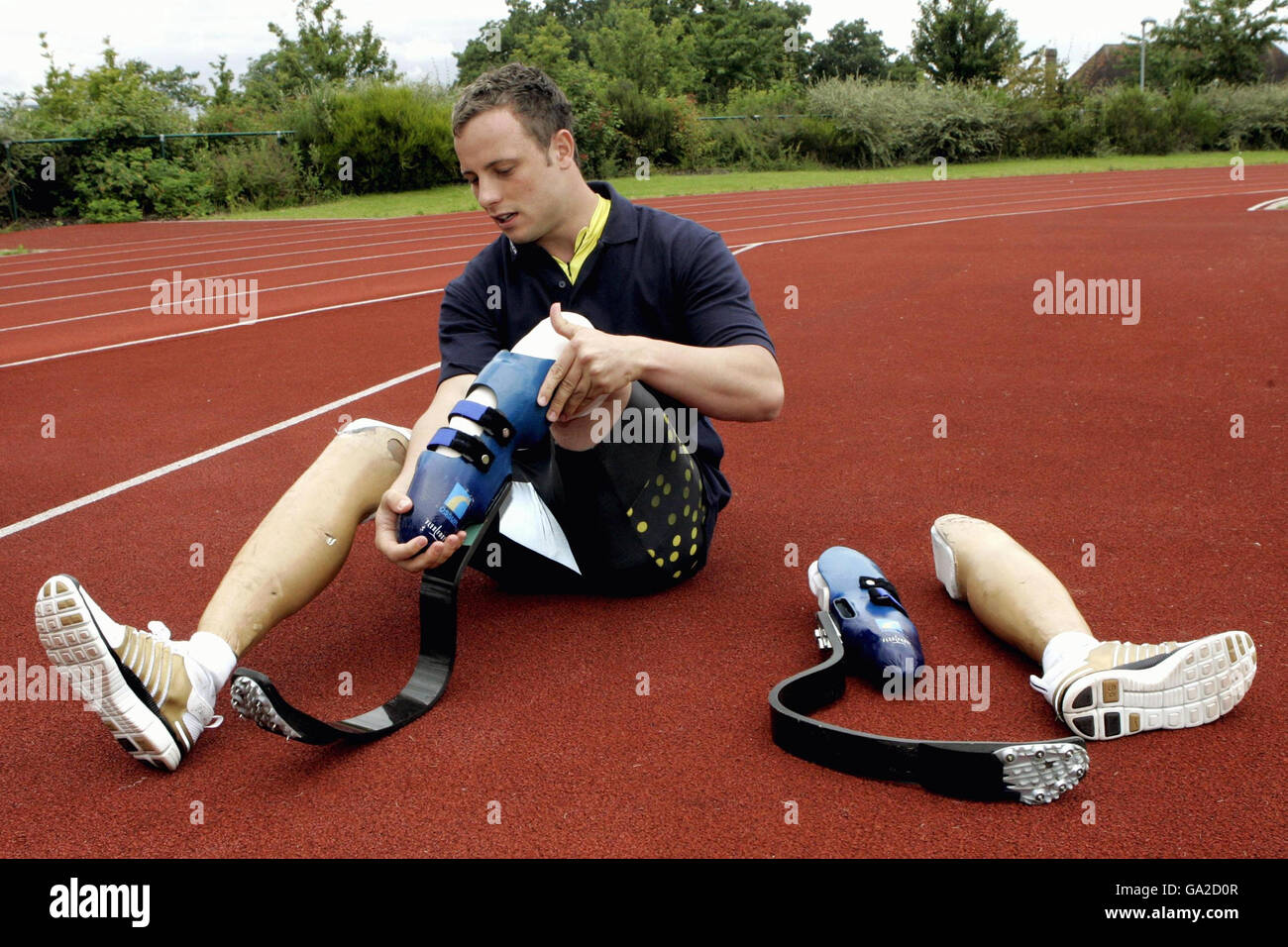 Double-amputee Oscar Pistorius puts on his running shoes at Brunel University, Uxbridge, London. Stock Photo