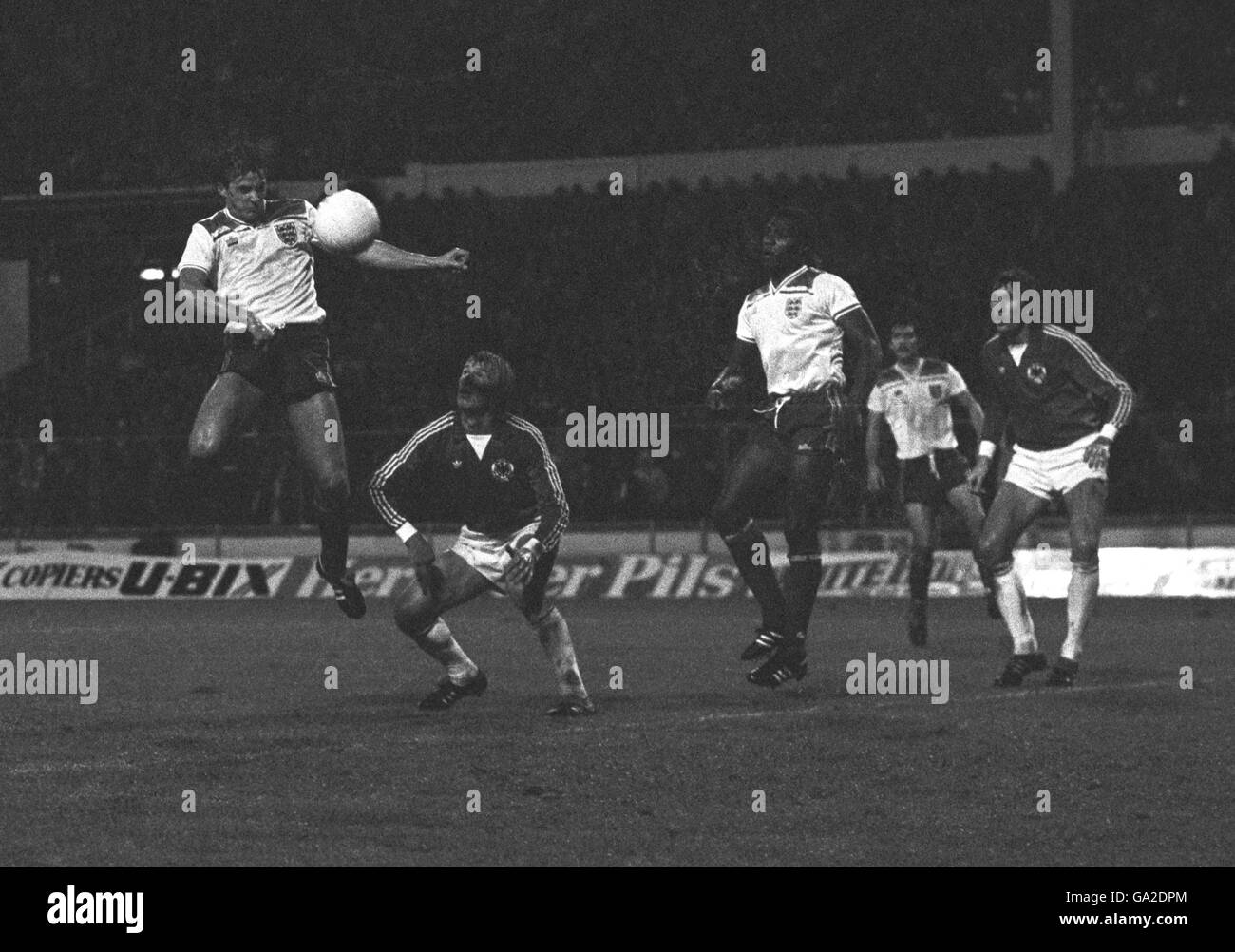 England's new international, Gary Mabbutt (l) powers a header towards the West German goal, saved by goalkeeper Harald Schumacher as England substitute Luther Blissett (c) looks on during the friendly at Wembley. Germany won 2-1. Stock Photo