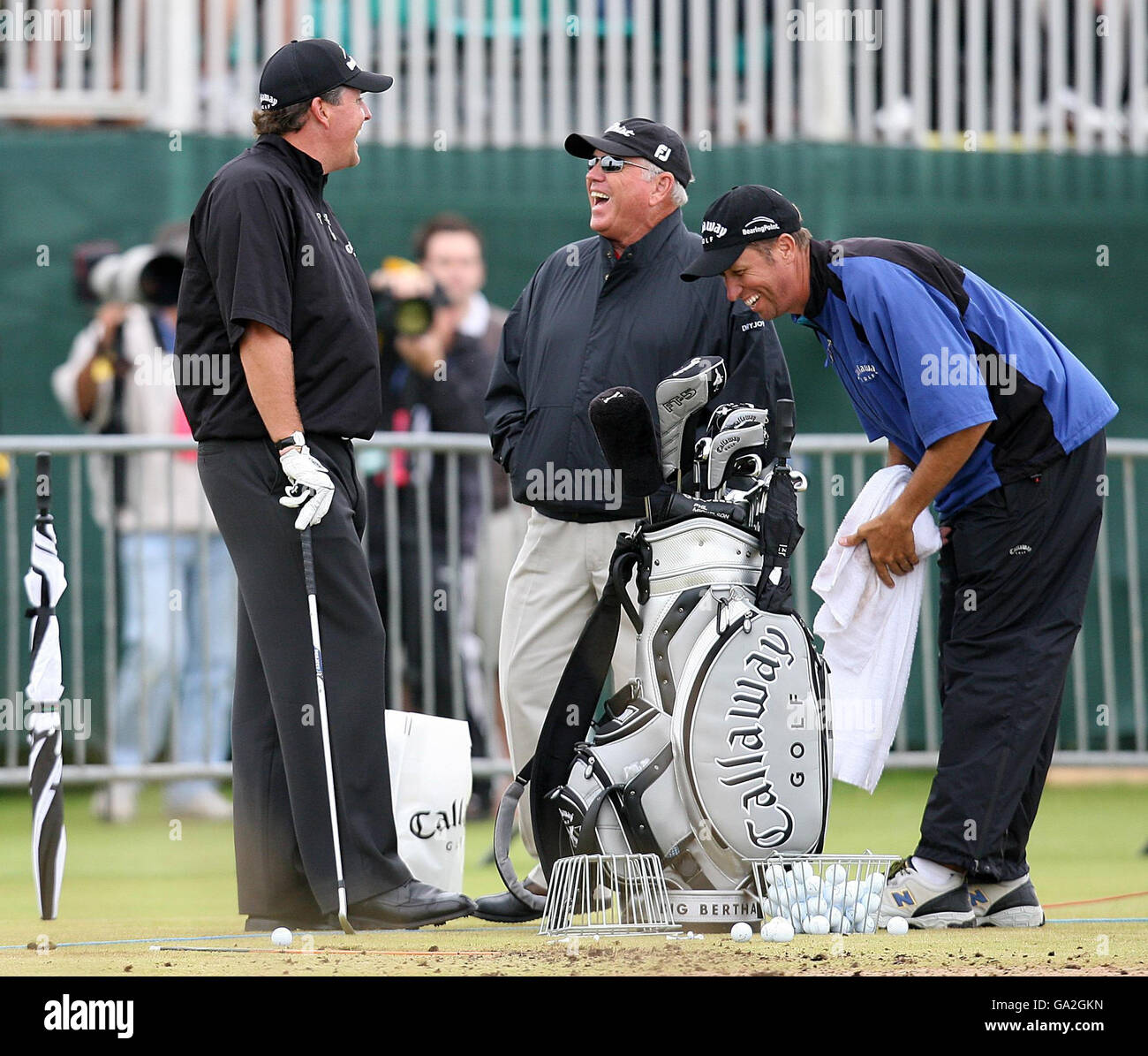 USA's Phil Mickelson shares a joke with Butch Harmon and his caddie on