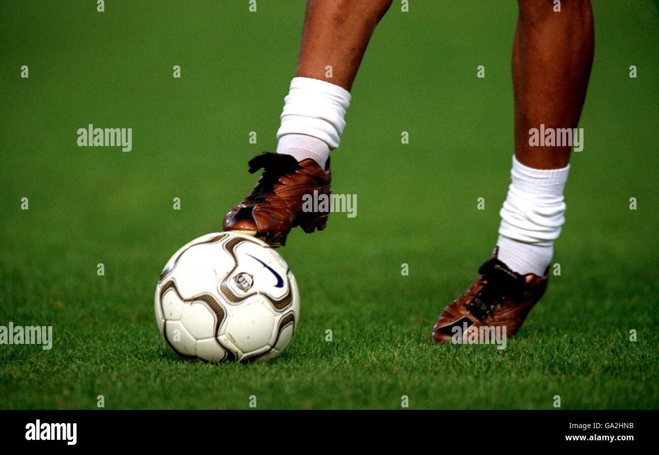 Soccer - UEFA Cup - Second Round - Second Leg - Valencia v Legia Warsaw. A player wearing Nike boots with a football Stock Photo