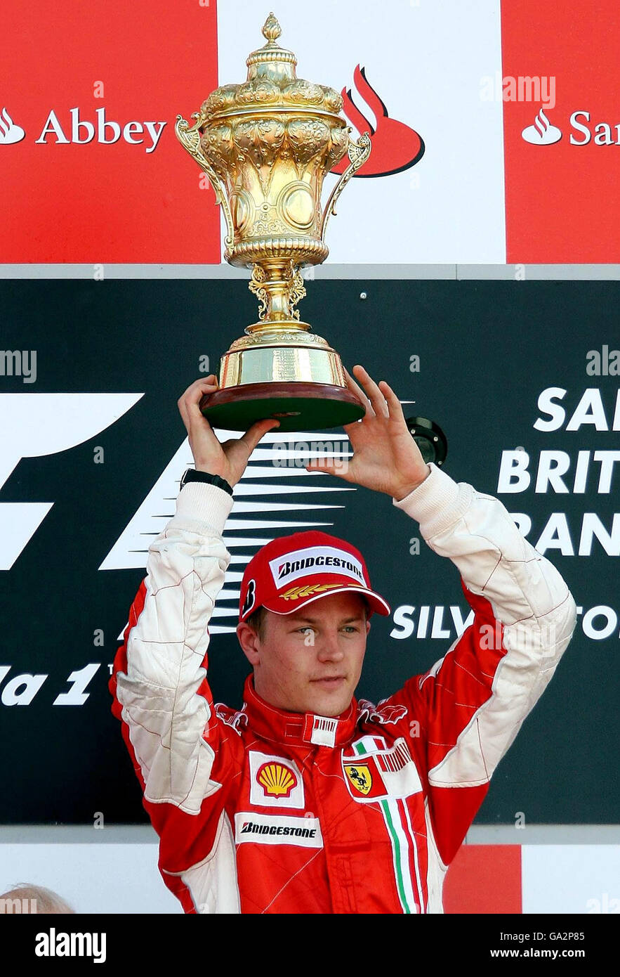 Ferrari's Kimi Raikkonen with the winners trophy on the podium after  winning the British Grand Prix at Silverstone, Northamptonshire Stock Photo  - Alamy