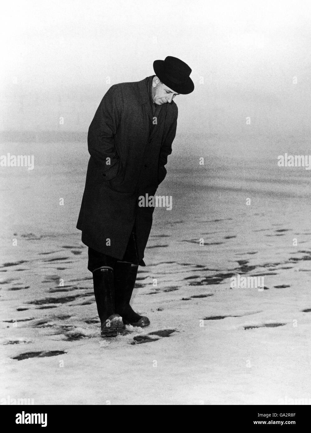 Referee Ken Aston inspects a pitch in the snow and fog during the Big Freeze of 1963 Stock Photo