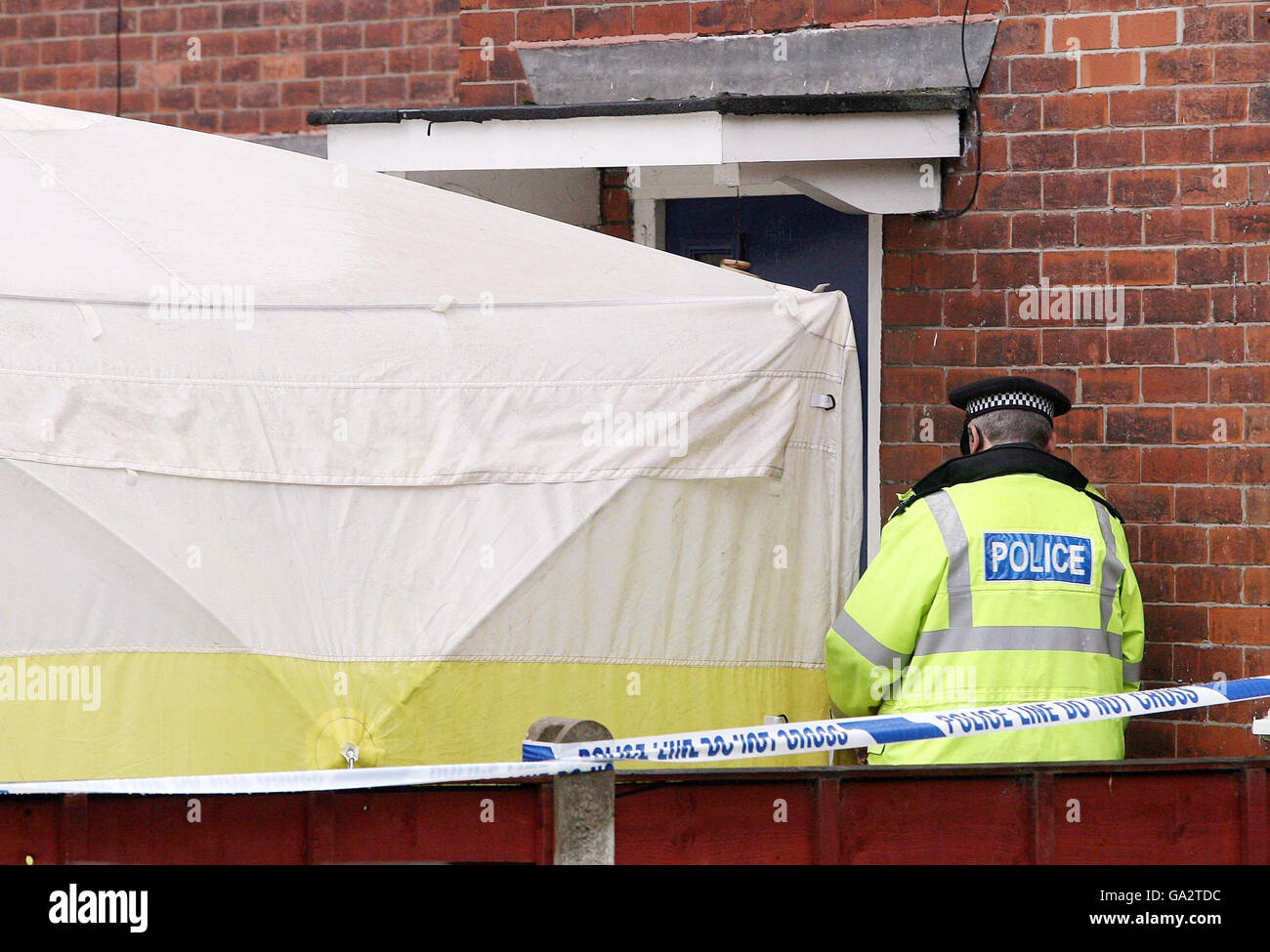 Three found dead in Manchester house. Police officers on duty outside the a property on Thelwall Avenue in Fallowfield, south Manchester. Stock Photo