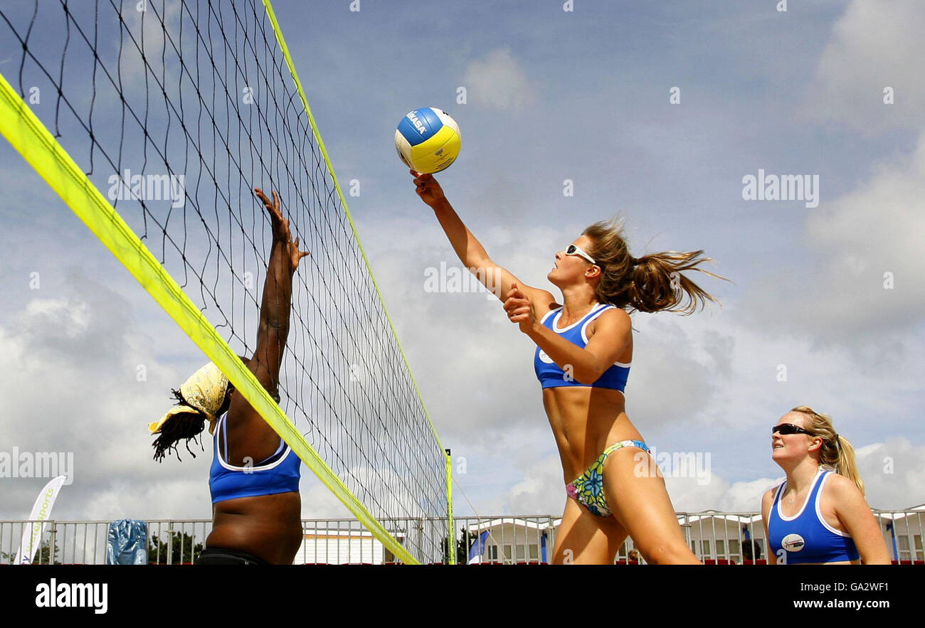 Britain's Zara Dampney (centre) and Shauna Mullin (right) in action during the Division One match at the Sandbanks Beach Classic Volleyball Tournament at Sandbanks in Dorset. Stock Photo