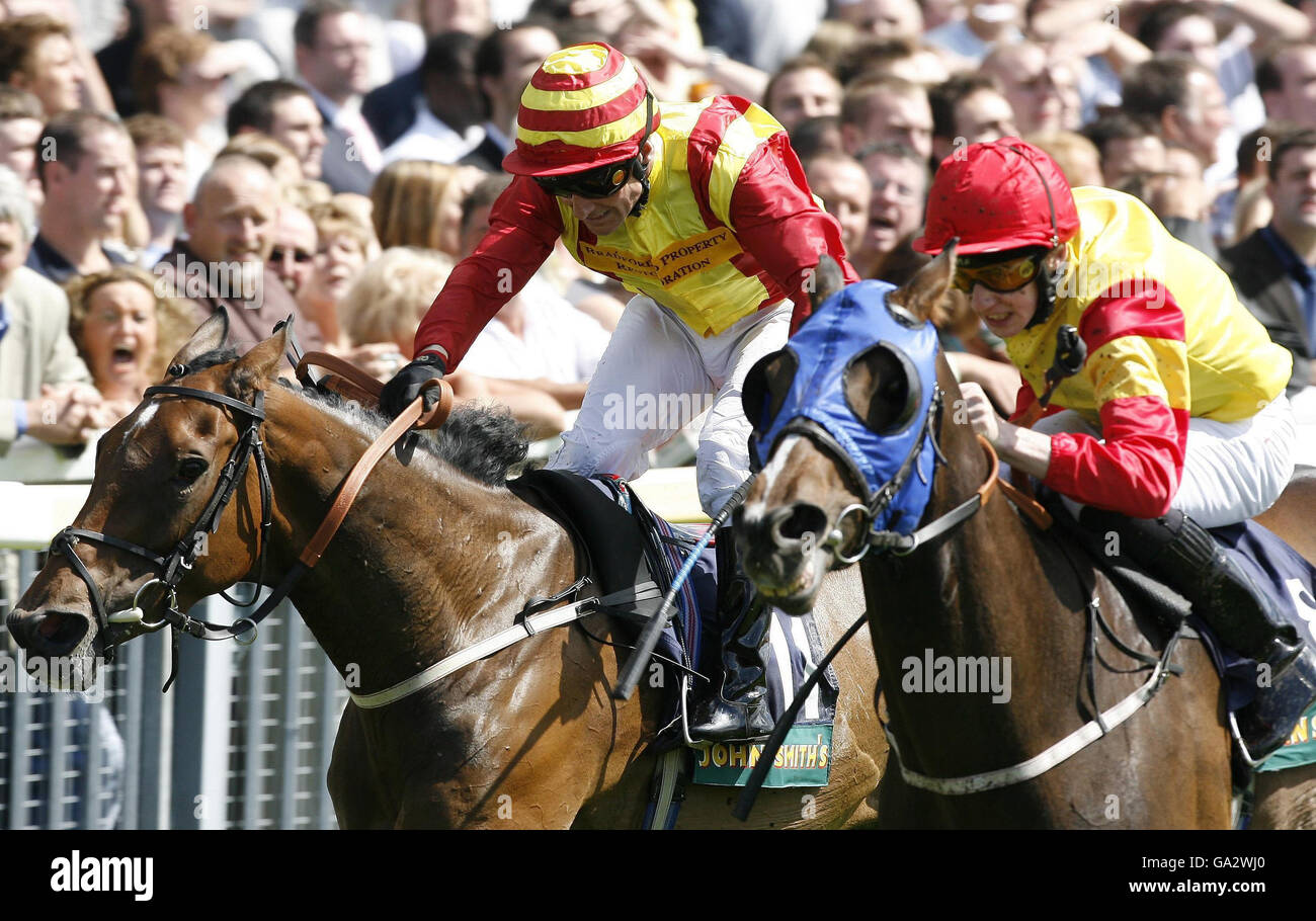 Charlie Tokyo (right) ridden by Jamie Moriarty wins the John Smiths Cup at York from Flying Clarets ridden by Kevin Darley at York Racecourse. Stock Photo