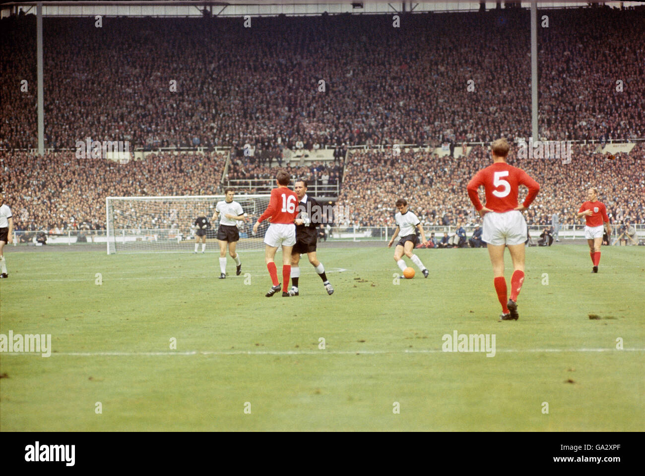 England's Martin Peter's (16) is repremanded by the referee as Jackie Charlton (5) looks on Stock Photo