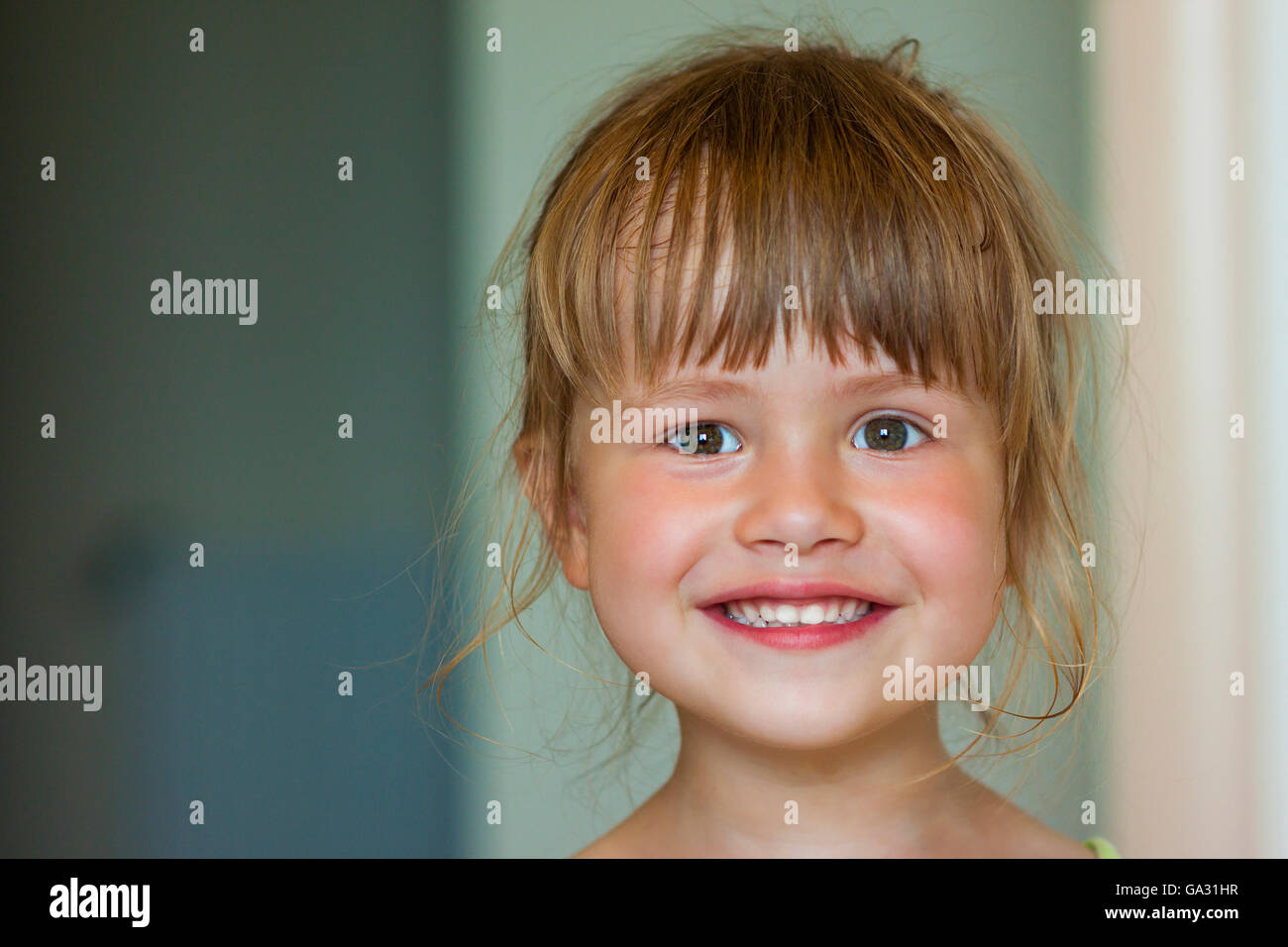 Portrait of a little smiling girl on blurred background Stock Photo - Alamy