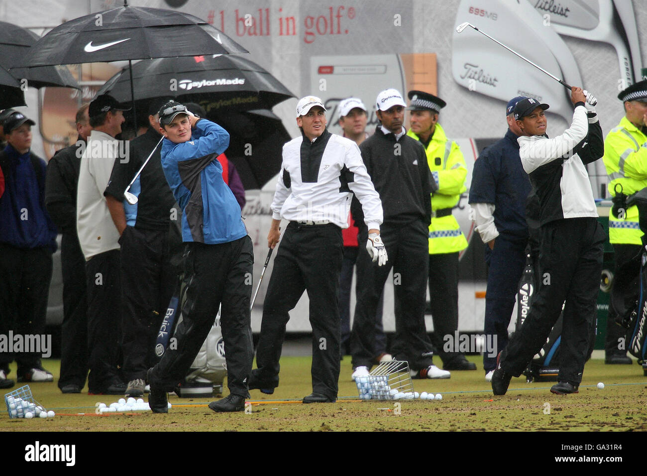USA's Tiger Woods (right) and England's Ian Poulter (centre) and Justin