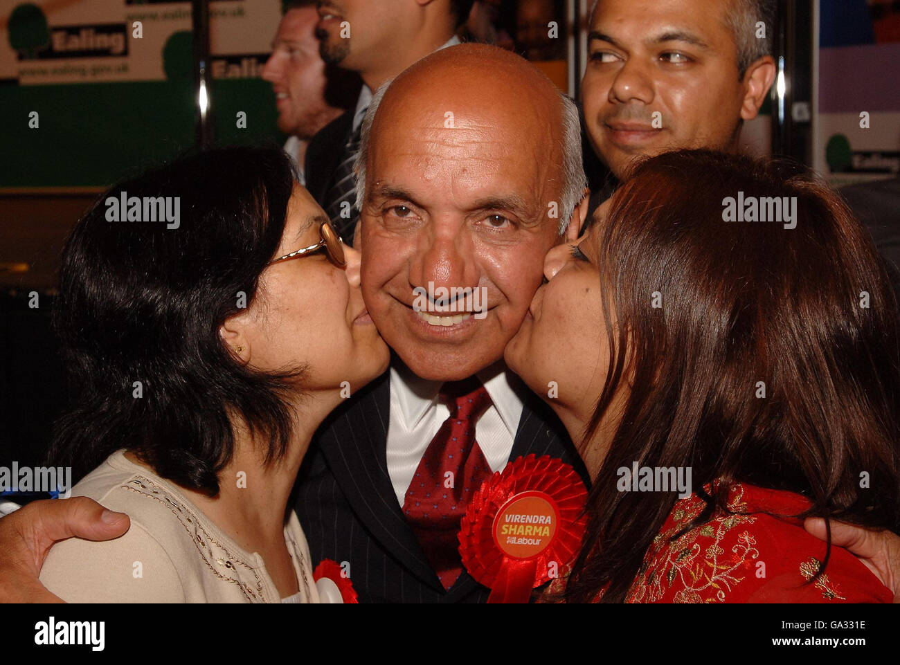 Labour's Virendra Kumar Sharma, is kissed by wife Nirmala (left) and daughter Monica, after he was elected for Parliament at the Ealing Southall By-Election this morning at Ealing Town Hall, west London. Stock Photo
