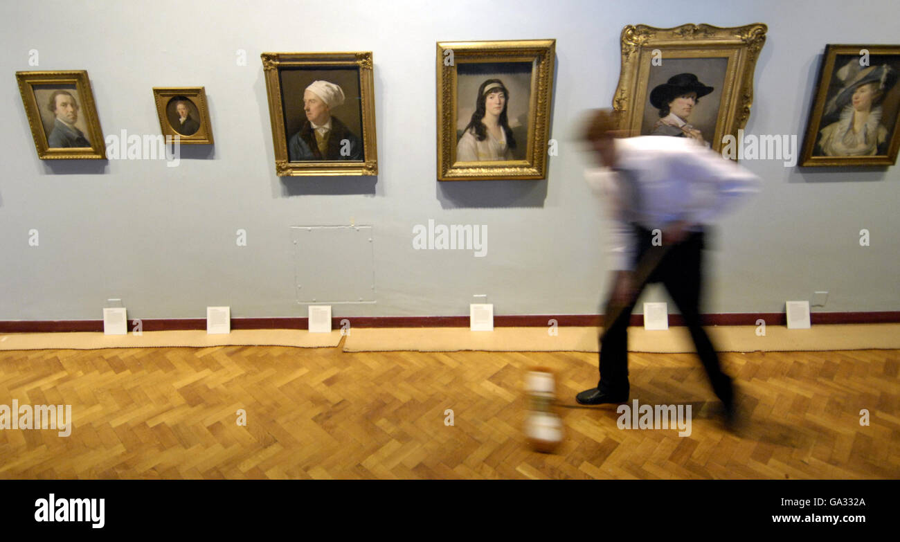 A cleaner sweeps the floor ahead of the Painting in Crayons: Pastel Portraits exhibition on show at Scottish National Portrait Gallery in Edinburgh, form 21 July to 30 September 2007. Stock Photo