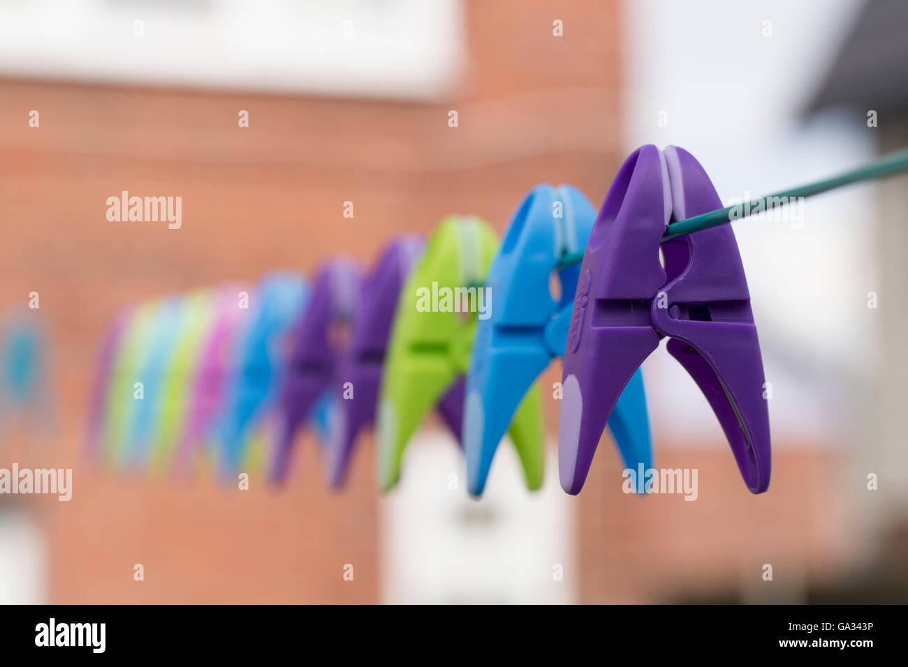 Colourful clothes peg on a washing line with beautiful bokeh. Stock Photo