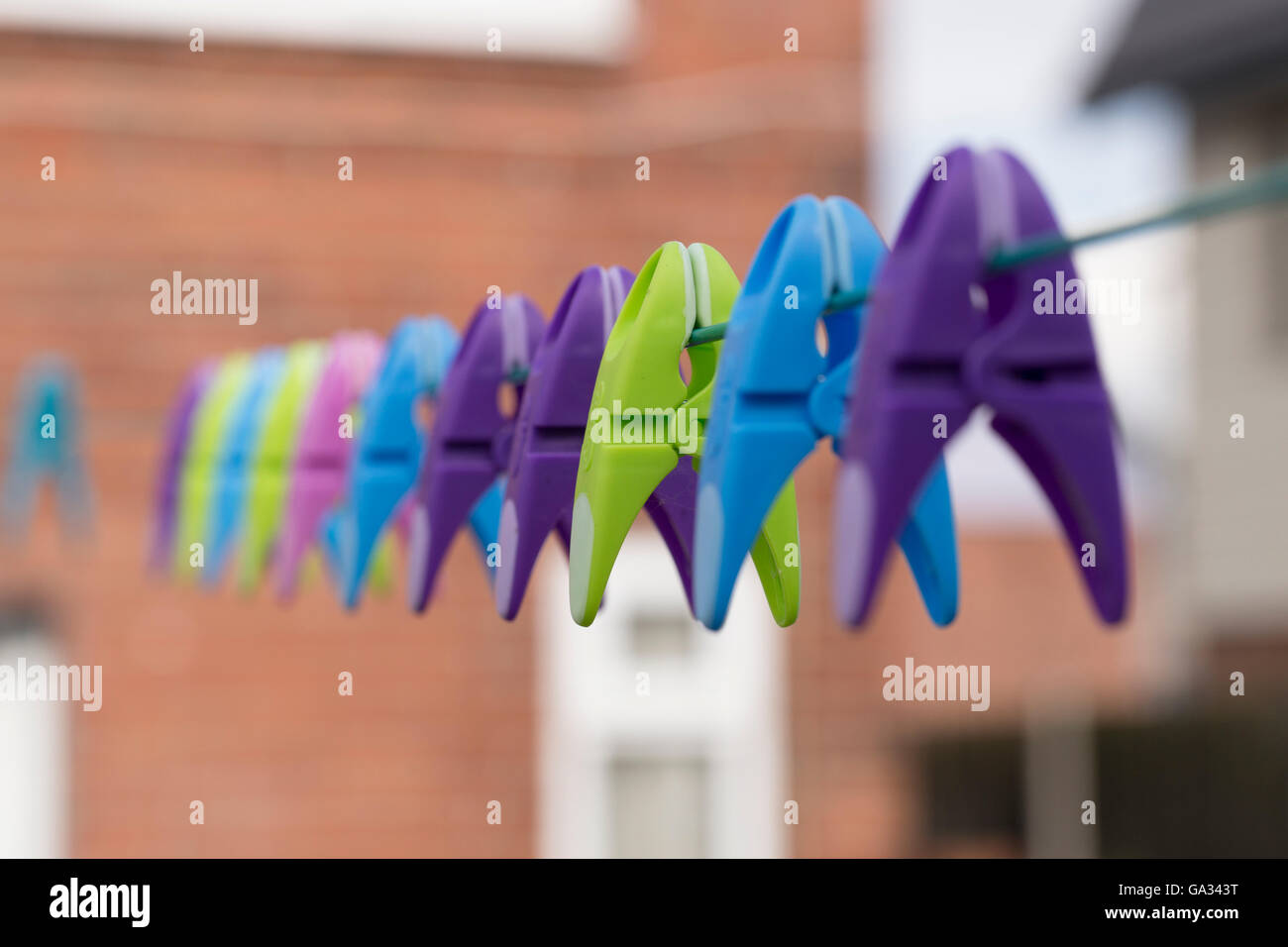 Colourful clothes peg on a washing line with beautiful bokeh. Stock Photo