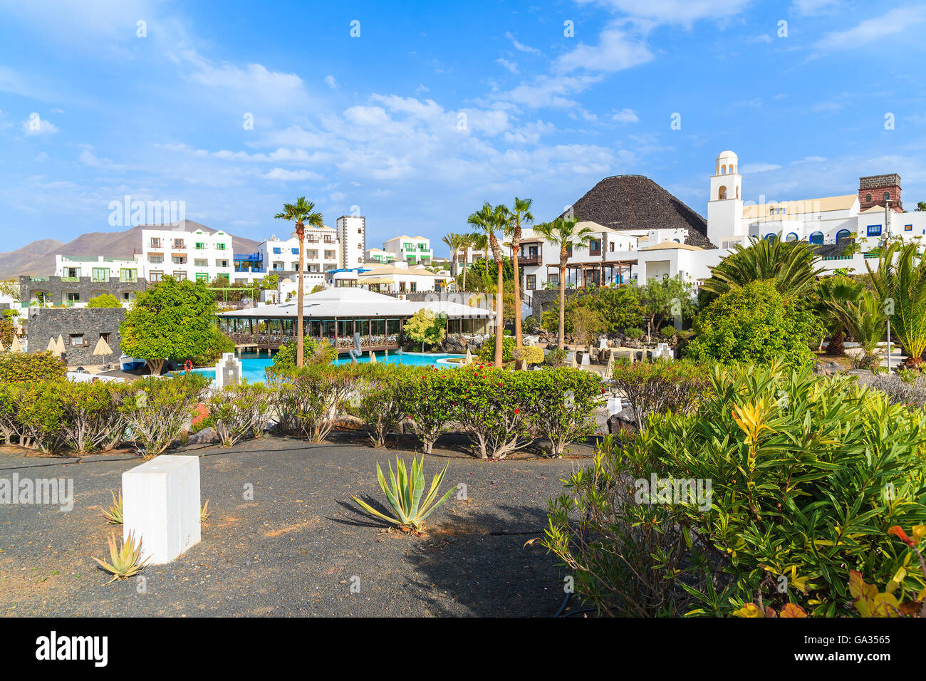MARINA RUBICON, LANZAROTE ISLAND - JAN 11, 2015: Volcan hotel garden with villas in Rubicon marina, which is a part of Playa Blanca holiday resort town. Canary Islands are popular holiday destination. Stock Photo