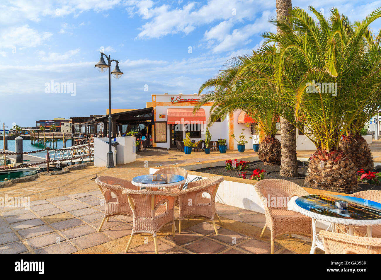 MARINA RUBICON, LANZAROTE ISLAND - JAN 11, 2015: restaurant tables in Rubicon port, Playa Blanca town. Canary Islands are popular holiday destination due to sunny tropical climate. Stock Photo