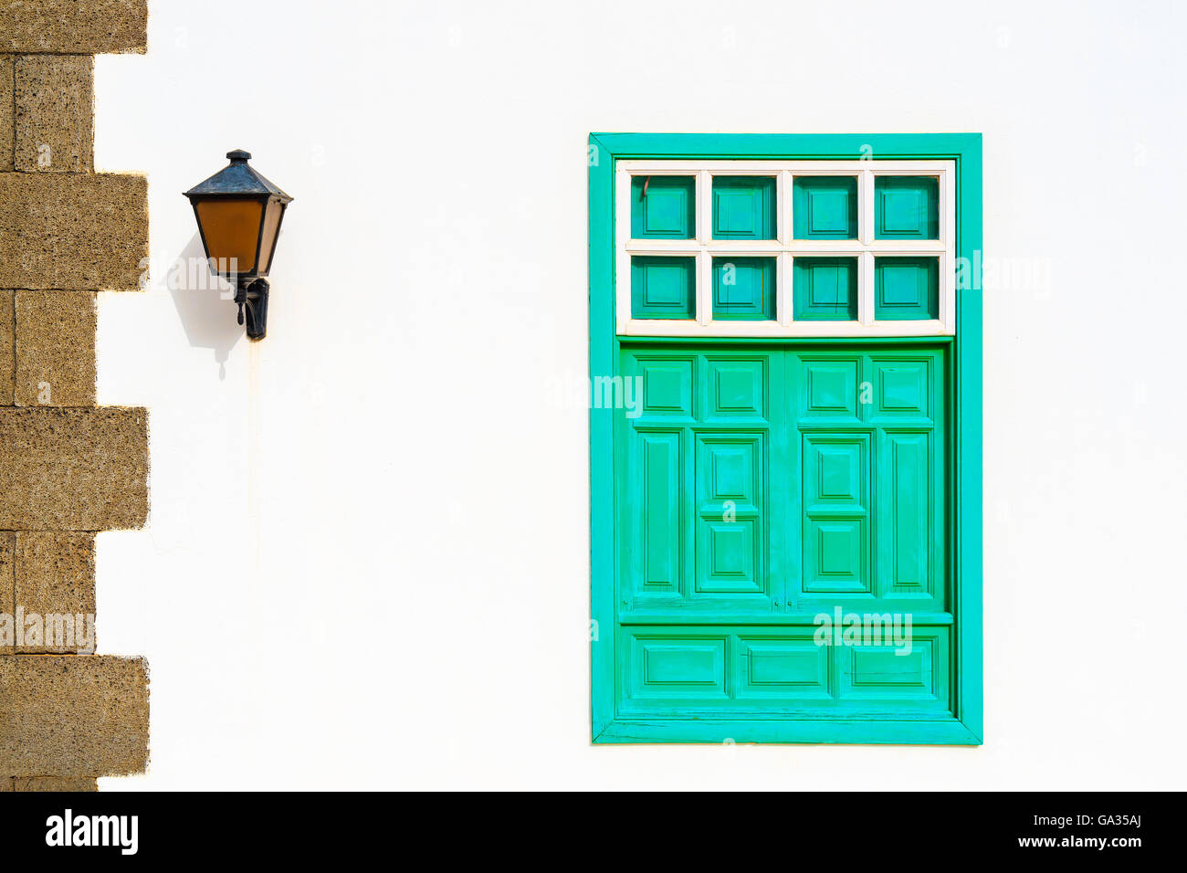 Green window of typical white house in Yaiza village, Lanzarote, Canary Islands, Spain Stock Photo