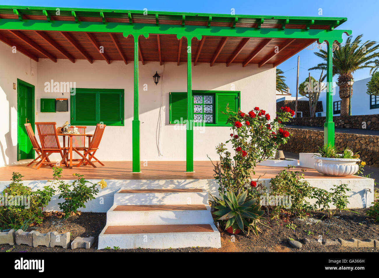 LANZAROTE ISLAND, SPAIN - JAN 15, 2015: typical white house with green door and windows in Las Brenas village. Lanzarote island is popular place to buy residential properties for winter vacation. Stock Photo