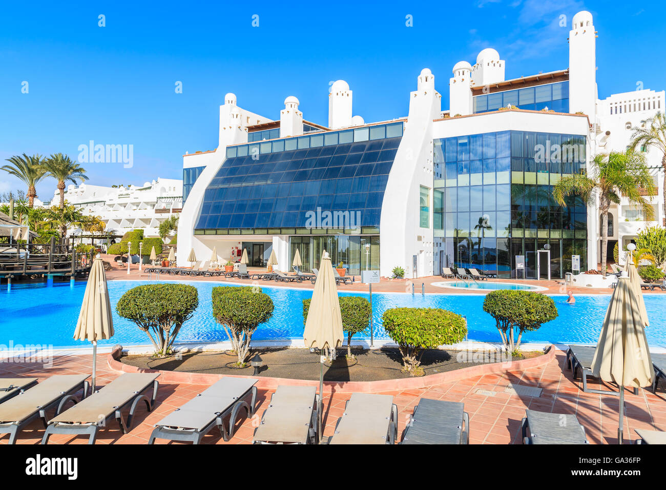 PLAYA BLANCA, LANZAROTE ISLAND - JAN 16, 2015: luxury hotel with pool in Playa Blanca holiday resort on coast of Lanzarote island. Many tourists come here to enjoy winter sunshine and relax. Stock Photo