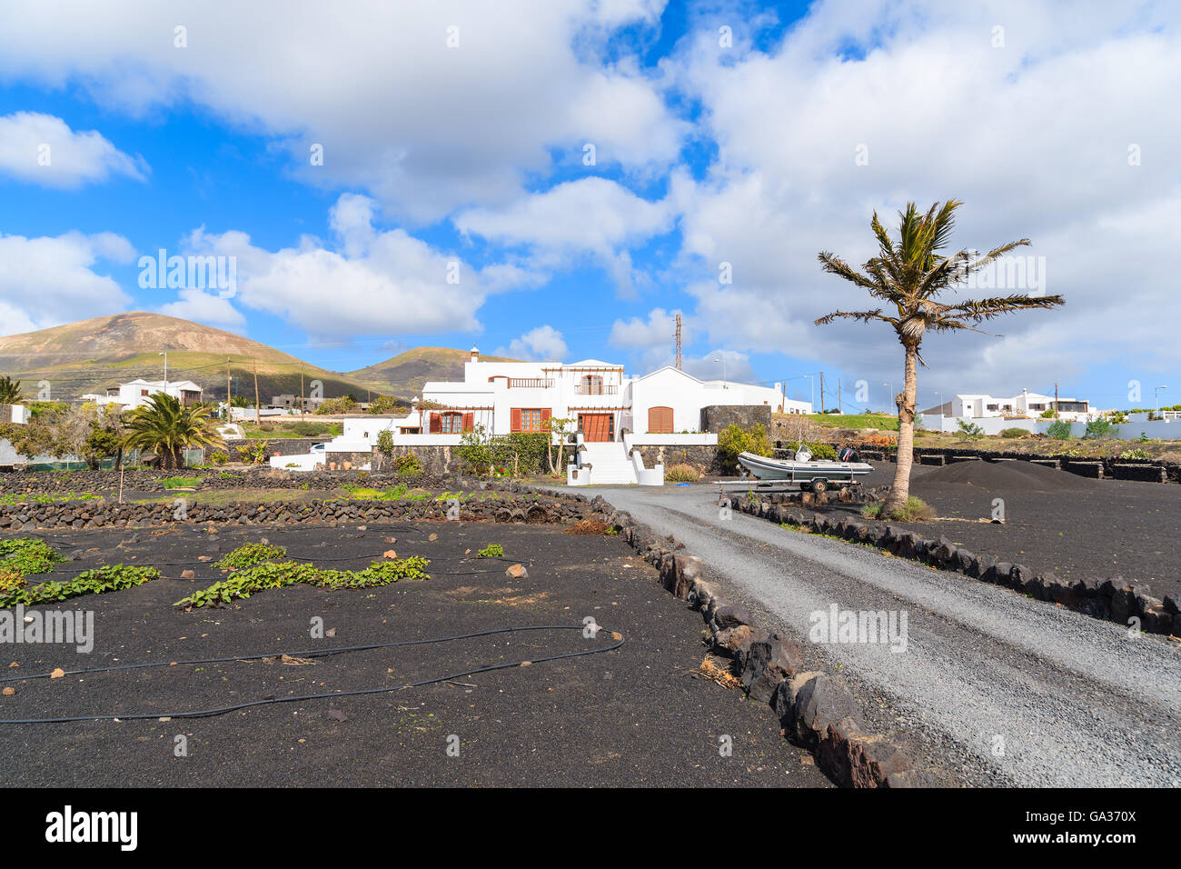 Road to typical Canarian houses near Puerto de la Carmen, Lanzarote, Canary Islands, Spain Stock Photo