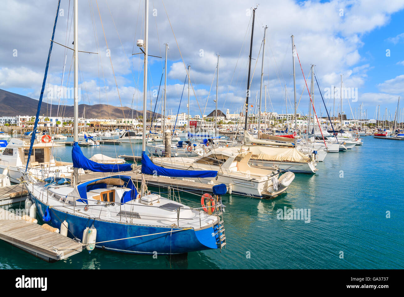 PLAYA BLANCA PORT, LANZAROTE ISLAND - JAN 17, 2015: yacht boats in Playa Blanca harbour on sunny day. Lanzarote is very popular tourist destination among Canary Islands archipelago. Stock Photo