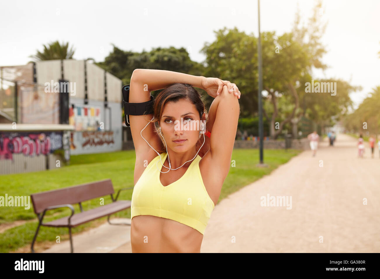 Young jogger 20-24 years old training while listening to music Stock Photo