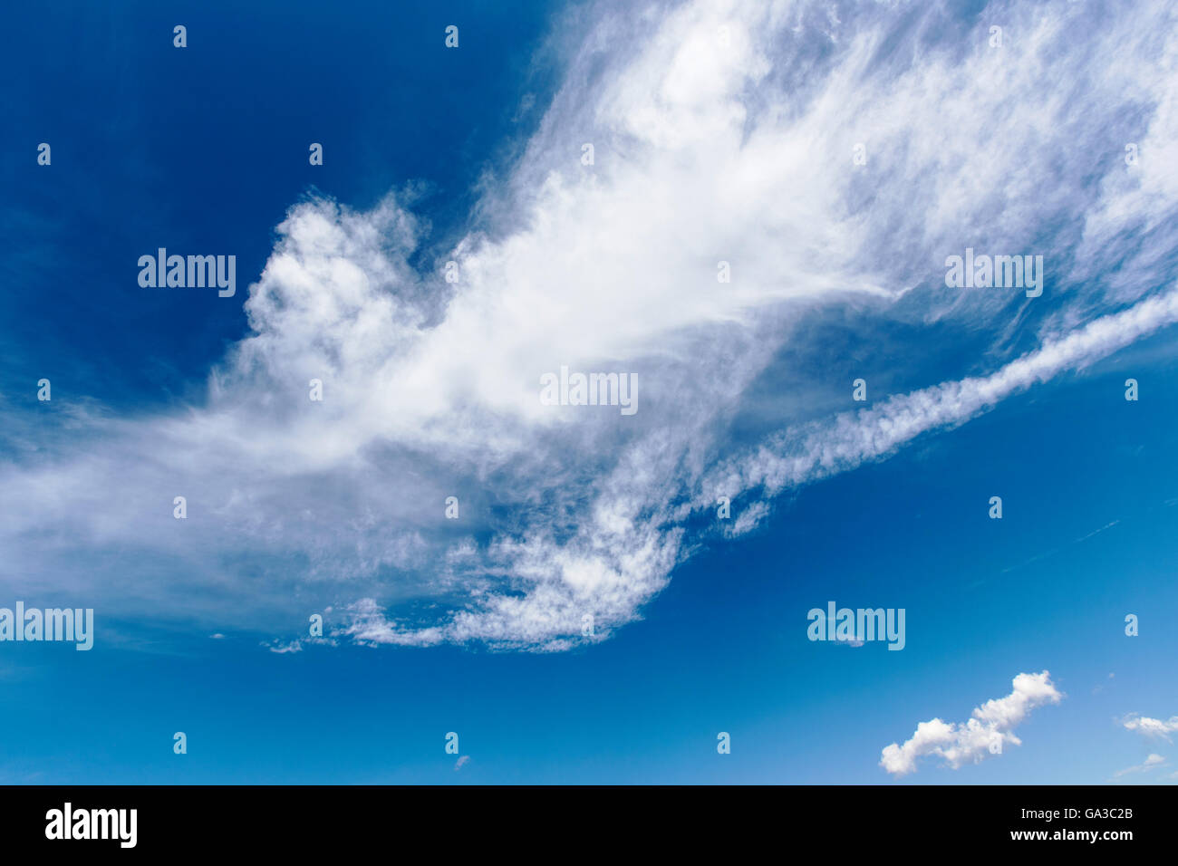 Fair weather high altitude clouds against a cobalt blue Colorado sky Stock Photo