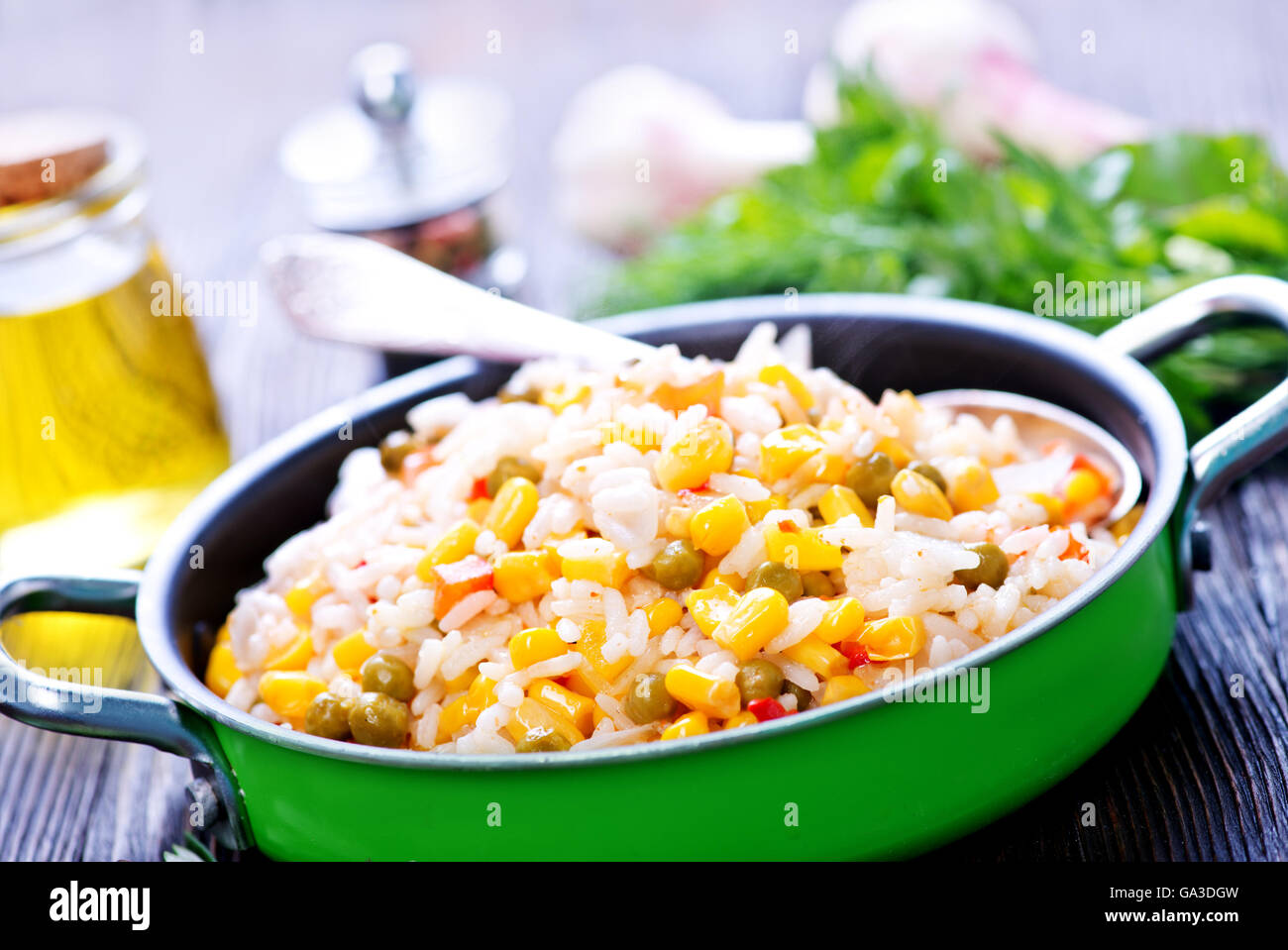 boiled rice with mix vegetables in bowl and on a table Stock Photo