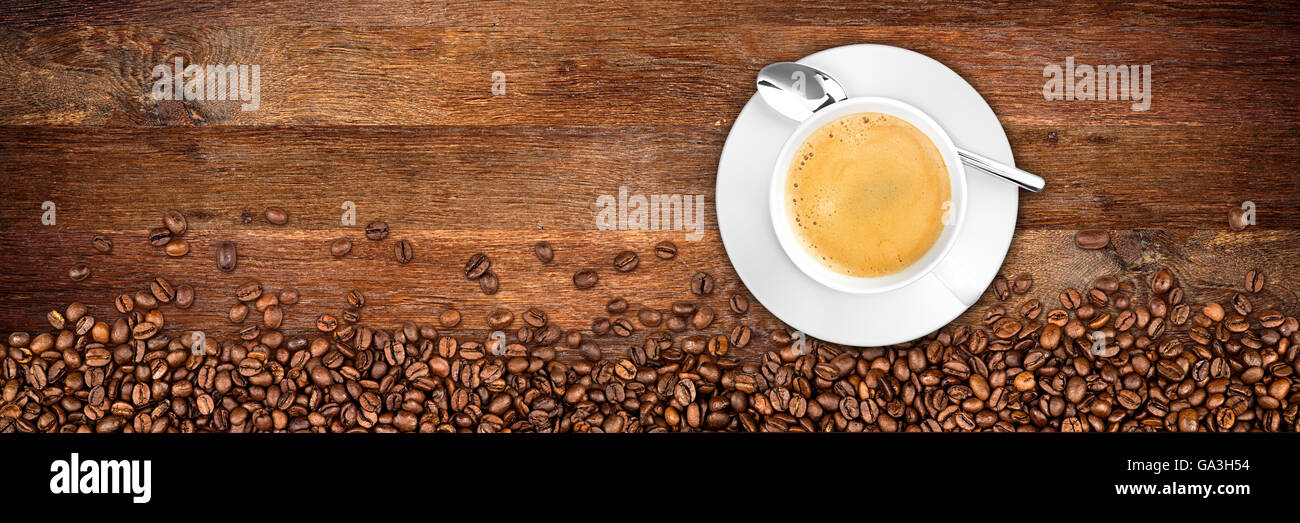 coffee cup and beans on wide rustic oak background Stock Photo