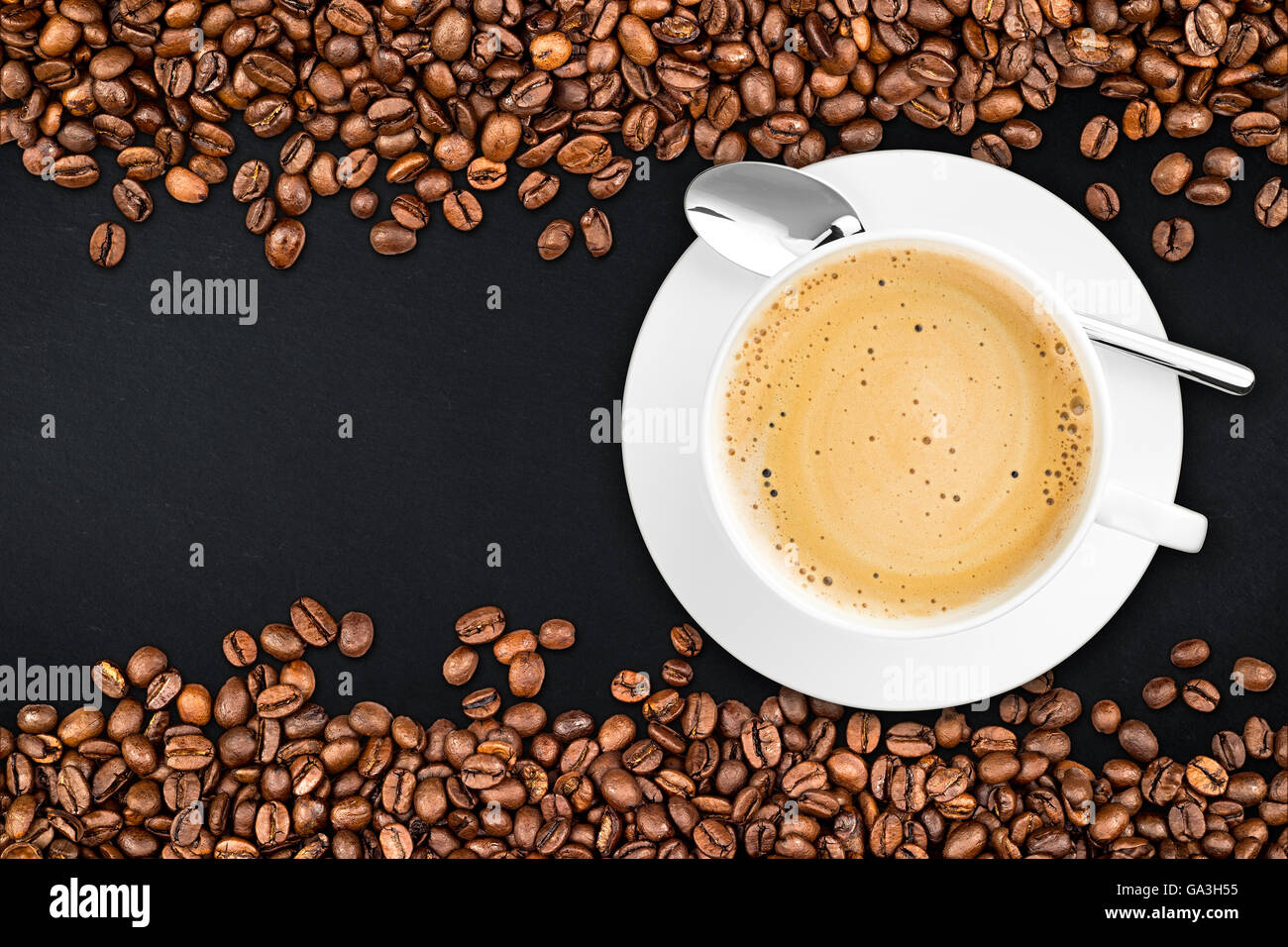 coffee cup and beans on rustic slate background Stock Photo