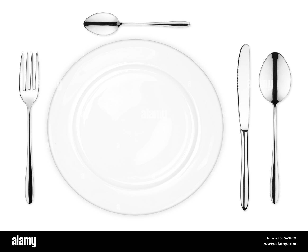 place setting with empty dish fork spoon and knife isolated on white background Stock Photo