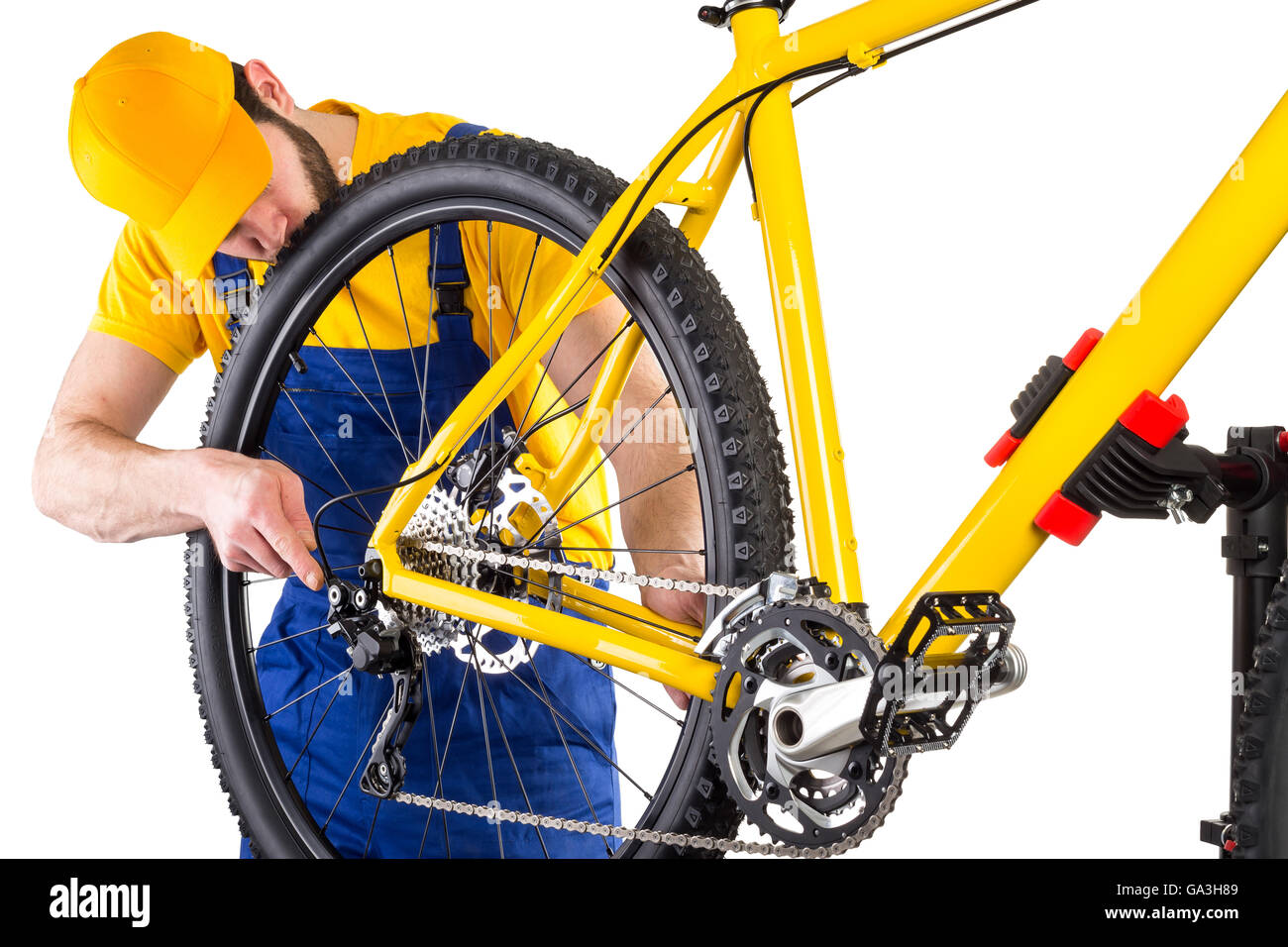 bicycle mechanic working on yellow mountain bike Stock Photo