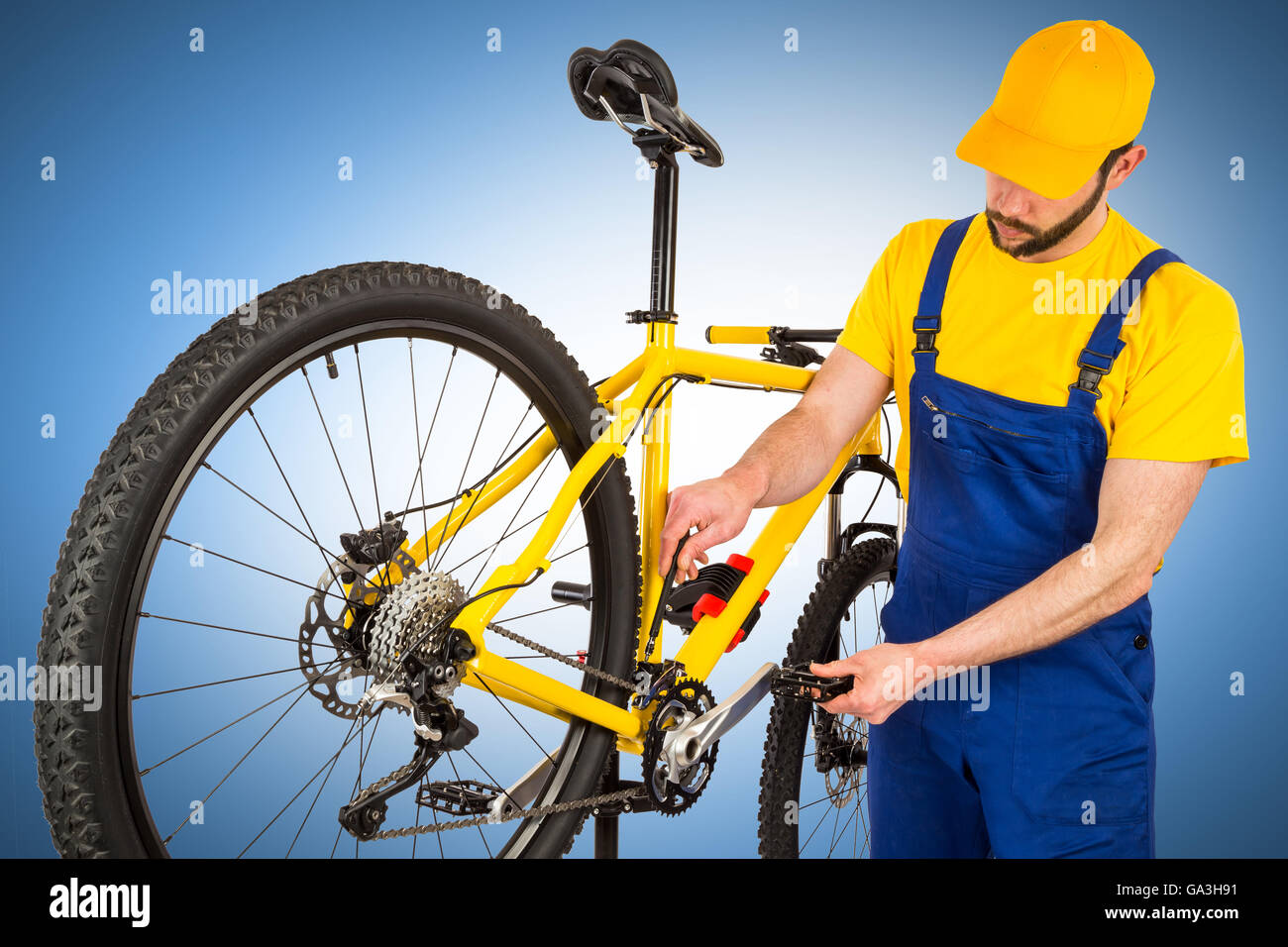 bicycle mechanic adjusting front derailleur mechanism on mountain bike