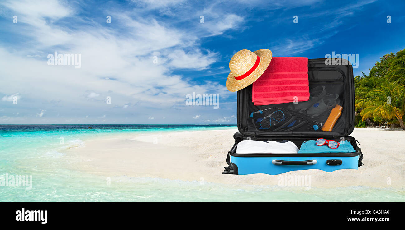 suitcase on paradise beach with crystall clear ocean Stock Photo