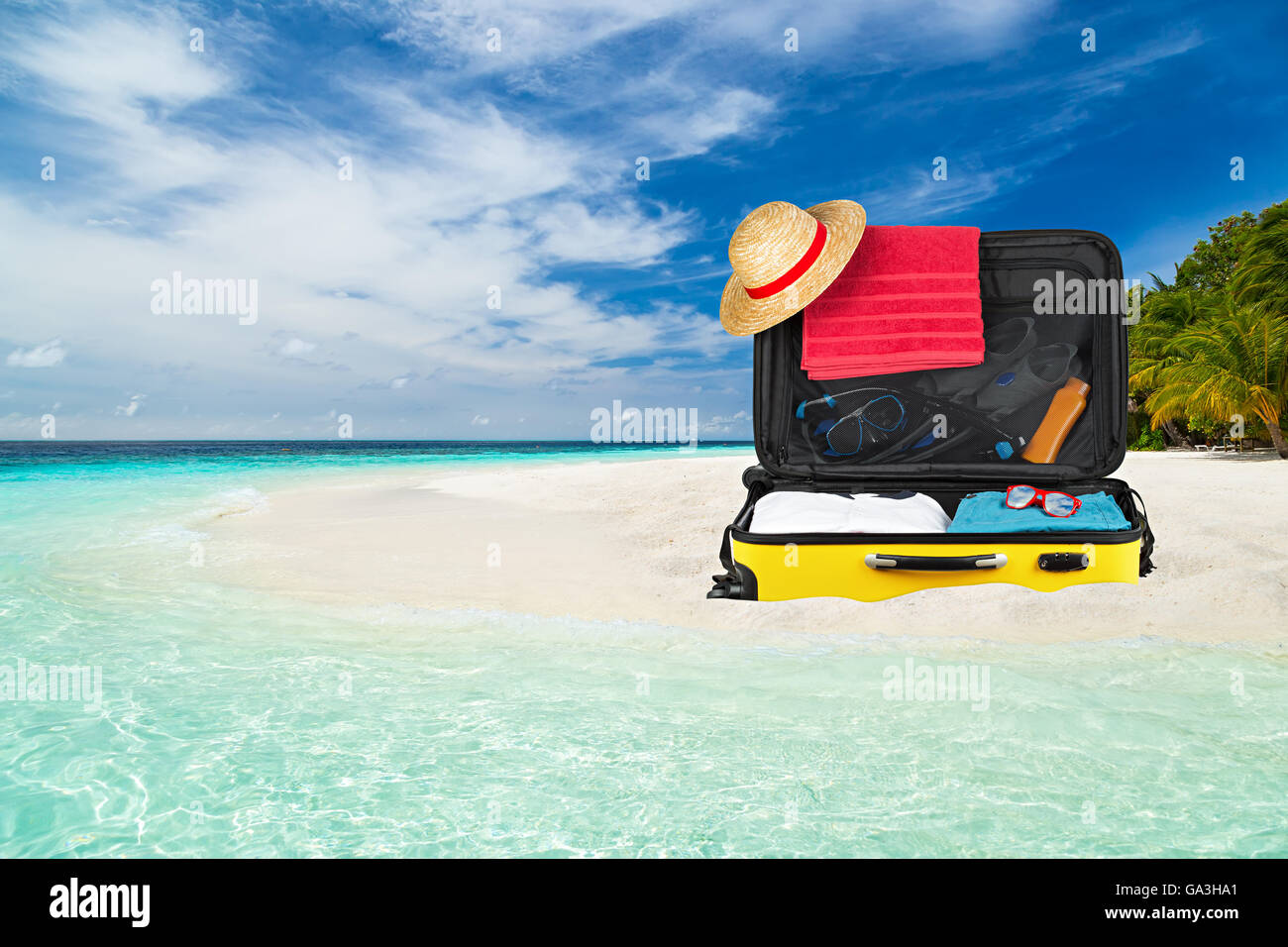 suitcase on paradise beach with crystall clear ocean Stock Photo
