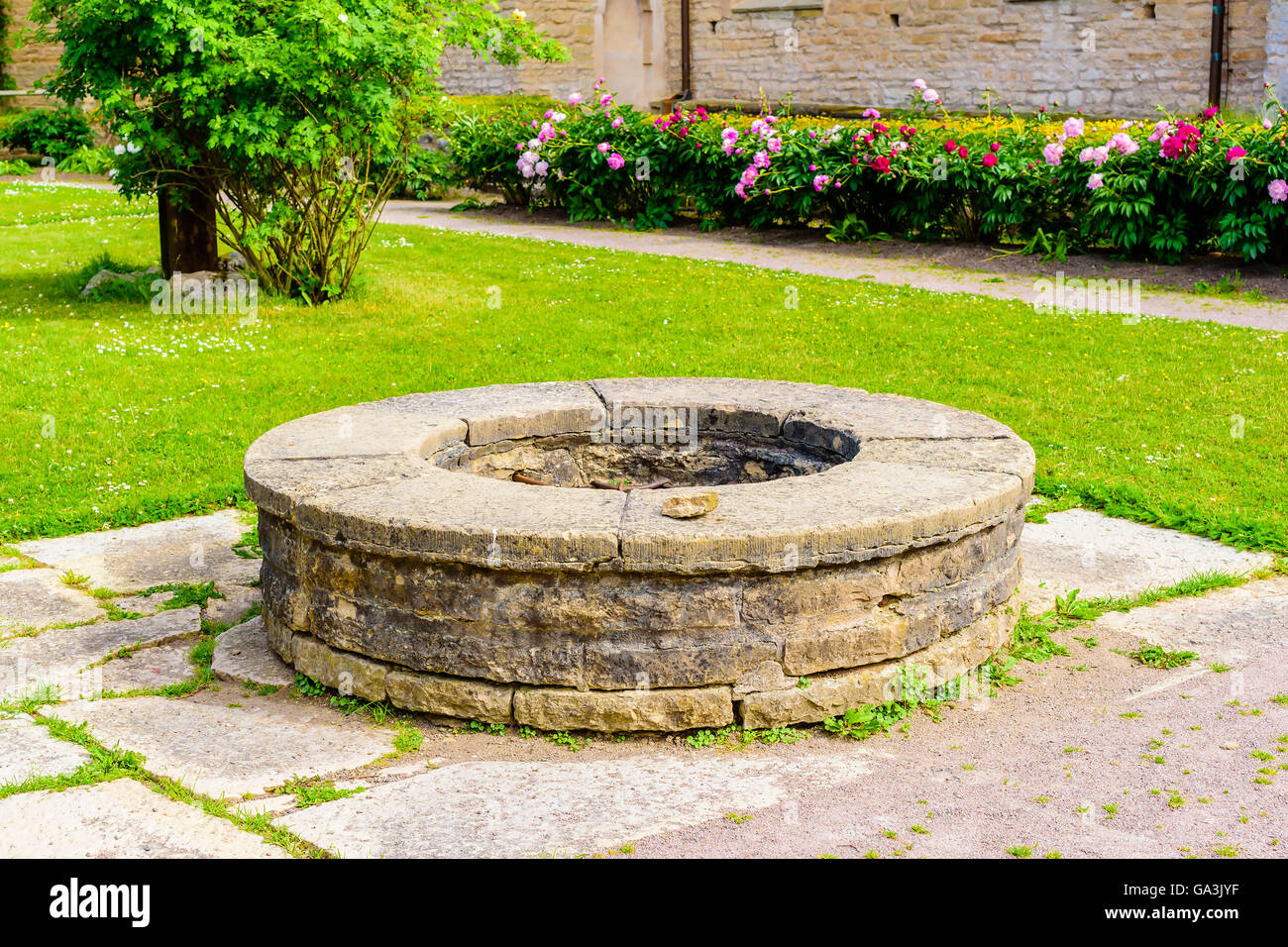 Vreta, Sweden - June 20, 2016: The old and humble well in the middle of the ancient cloister garth. Stock Photo