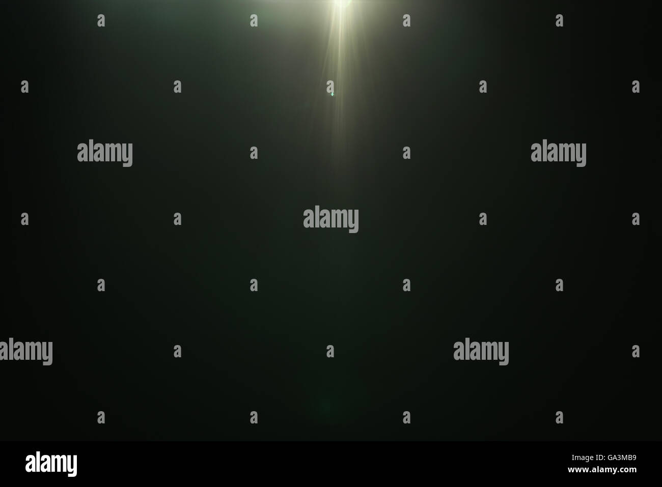 real green lens flare over dark background Stock Photo