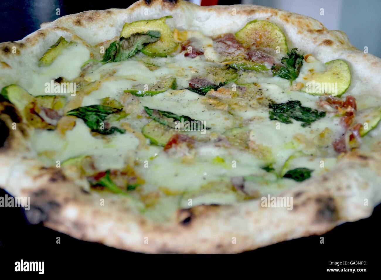 Torre Del Greco, Italy. 02nd July, 2016. This is 'Eva pizza' (by 'Officina della Pizza' in Torre del Greco) with figs, bacon and provolone of Agerola. Pizza is one of the most famous Italian dishes. It finds its best expression in Naples. © Maria Consiglia Izzo/Pacific Press/Alamy Live News Stock Photo