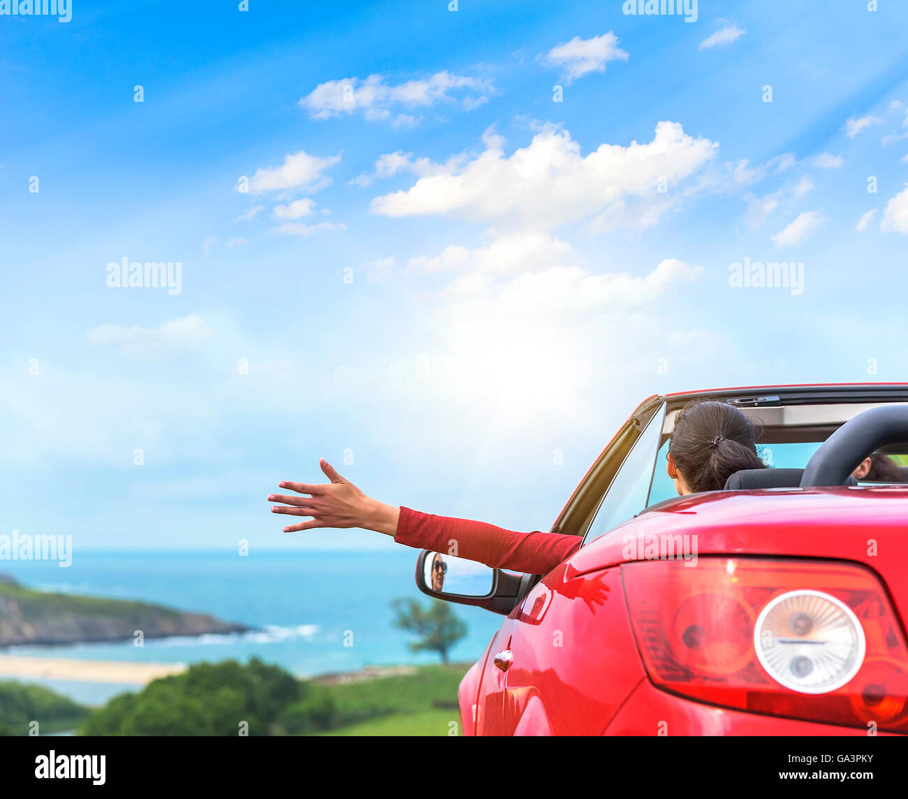 Girl in a red convertible car on a background seascape Stock Photo - Alamy