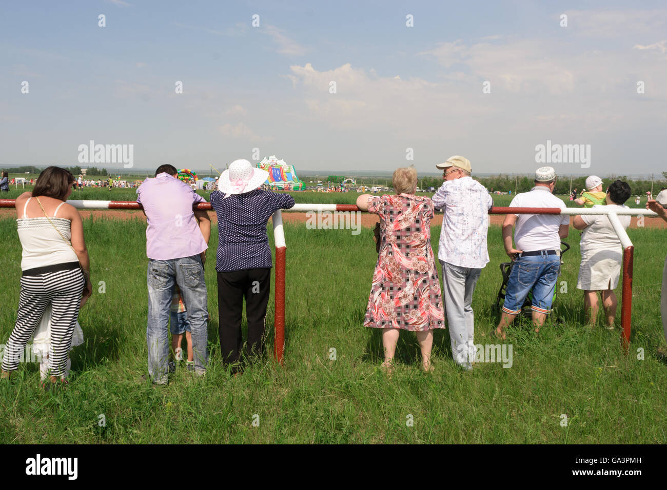 People watching a sporting event horse racing as spectators Stock Photo