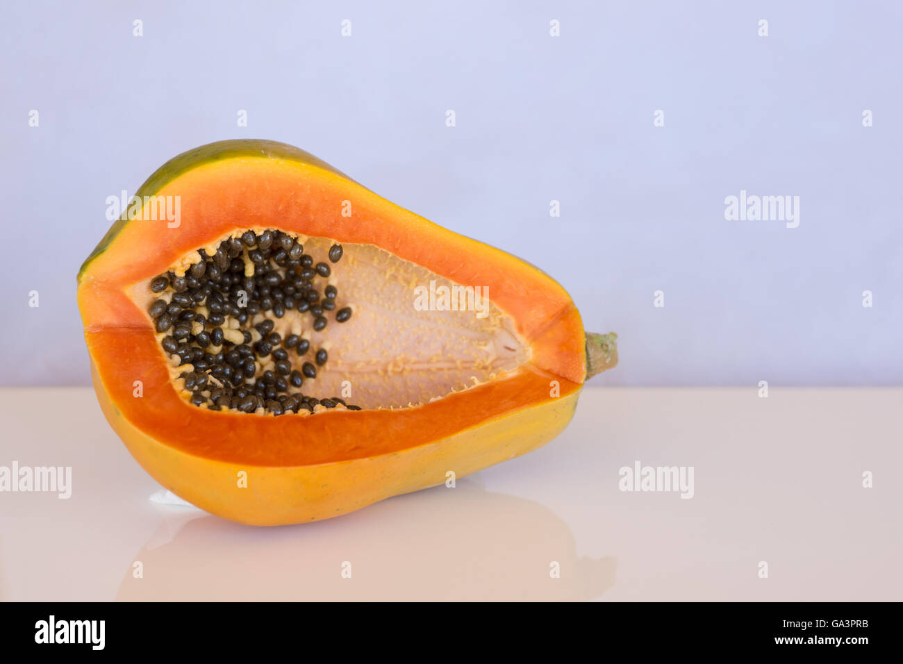 Ripe papaya / paw paw with orange flesh and seeds with copyspace Stock Photo