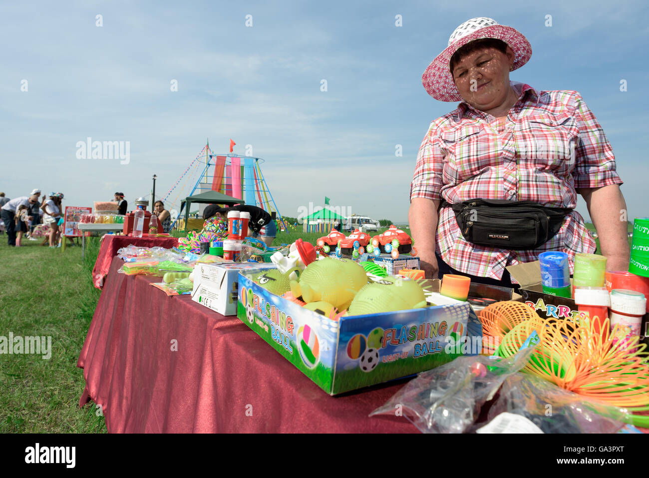Woman selling toys for Children at an outdoor fair Stock Photo
